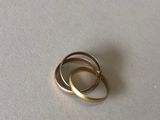 a close up of a gold ring on a white surface