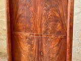 a wooden cabinet with two doors on the top