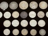 several different types of coins are arranged on a black surface