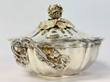 a silver bowl with a lid and a spoon in it