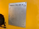 a metal plaque on the side of a yellow wall