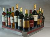 many bottles of wine in a display case on a table