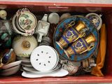 a red box filled with assorted items on a table