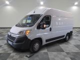 the white van is parked on a checkered tile floor