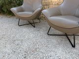 two chairs sitting next to each other on a gravel ground