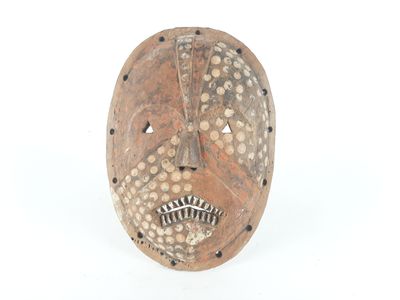 an image of a wooden mask with holes on it ' s face