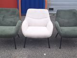 three chairs sitting next to each other in front of a garage door