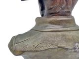 statue of a bust of a man wearing a hat with writing on it