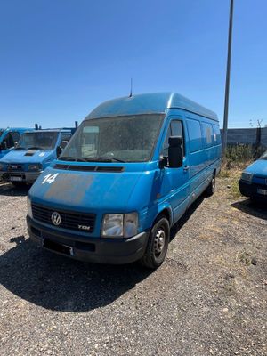 many blue vans parked in a parking lot