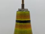 a green and yellow vase with a light on top of it
