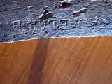 a close up of a piece of wood with writing on it