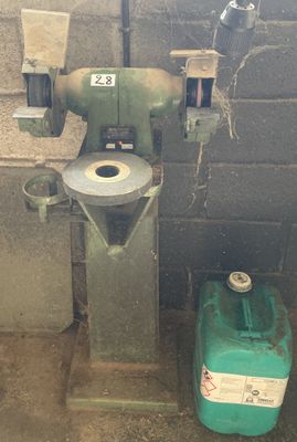 a machine that is sitting next to a green container