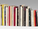 many books that are stacked on top of each other