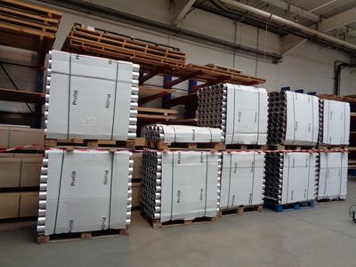a large amount of boxes stacked on pallets in a warehouse