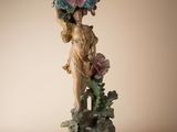 a figurine of a woman with flowers on her head