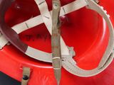 a red fire hydrant with a helmet and a pair of scissors on it