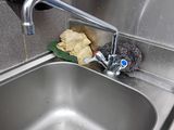 a sink with a sponge and a rag next to a faucet