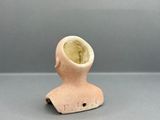 a small clay object with a hole in it