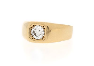 a close up of a gold ring with a diamond in the center