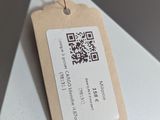 a tag that is attached to a white table