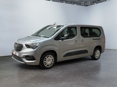 the silver van is parked in a large room with white walls