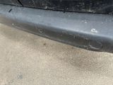 a close up of a car bumper with scratches on it