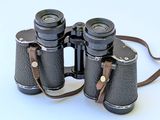 a pair of binoculars that are sitting on a white surface