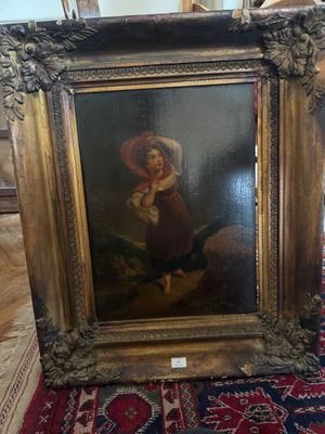 un vieux tableau représentant une femme en robe rouge est posé sur un tapis