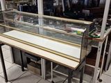a glass display case in the middle of a store