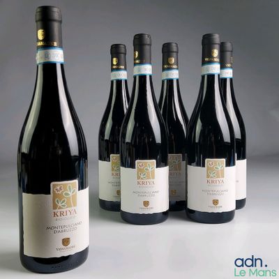 six bottles of wine are lined up in a row on a table