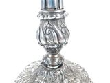 a silver candle that is sitting on top of a table