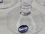 three wine glasses that are sitting on a table