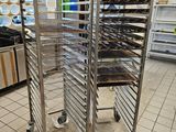 many trays of food that are on the rack in the kitchen
