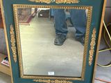 a mirror that is sitting on the floor in front of a dresser