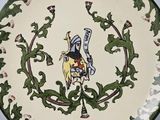 a decorative plate with a picture of a knight on it