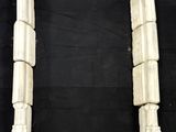 a pair of white marble columns on a black background