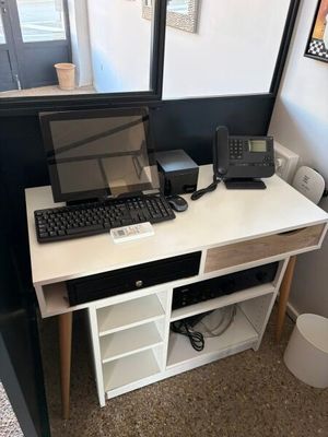 a computer desk with a keyboard and a monitor on it