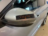 a car that has a sticker on it ' s side mirror