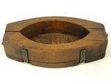 a wooden ashtray with metal handles on a white background