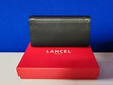 a black and red wallet sitting on top of a red box