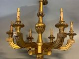an image of a gold chandelier hanging from a ceiling