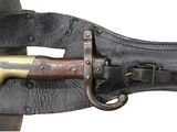 a close up of a knife with a leather sheath