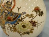 a white vase with a picture of a woman on it