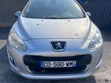 the front of a silver car parked in a parking lot