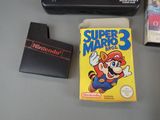 a nintendo game on the table next to a nintendo game