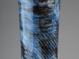 a close up of a blue vase on a table