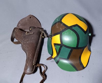 a helmet and a gun on a white table