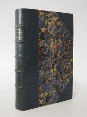 a book with a blue cover sitting on top of a white table