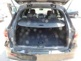 the back end of a car with the trunk open and the seats down