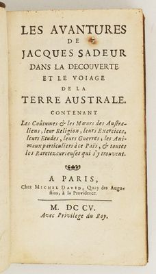 un livre ouvert posé sur une surface blanche, sur lequel figurent des inscriptions